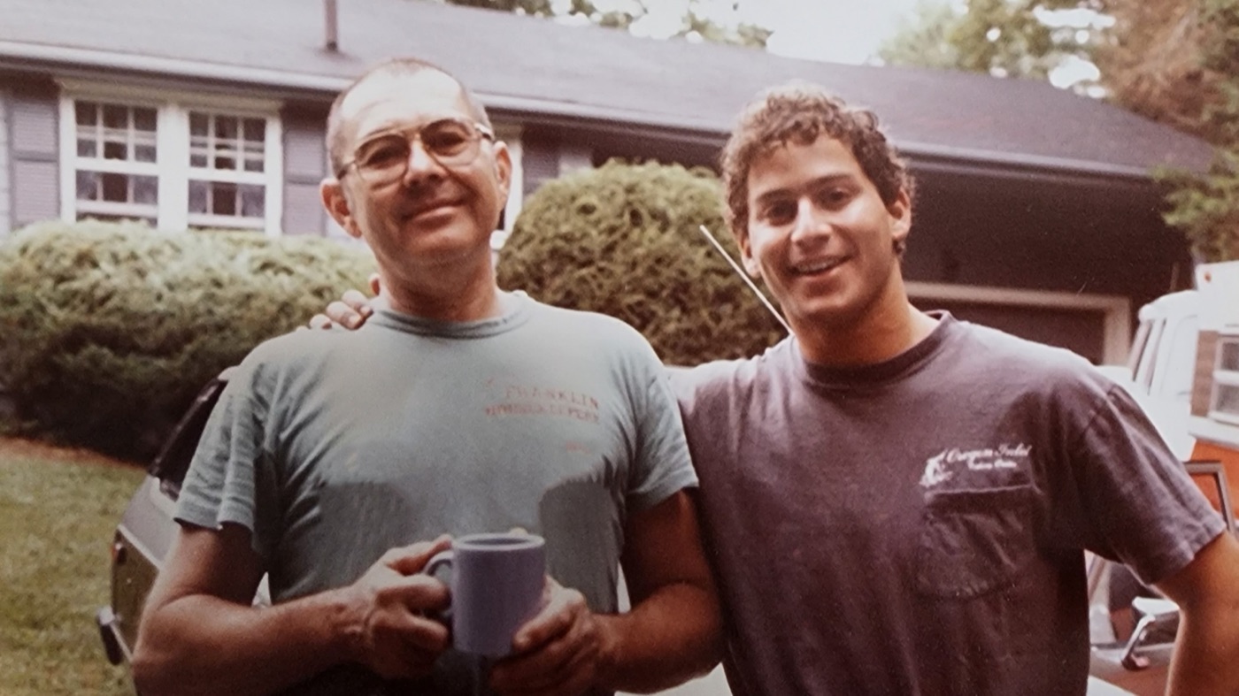 A young Mike Katz standing with his father in the family driveway